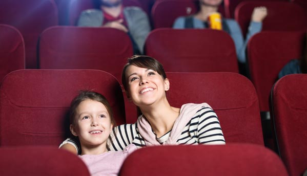 Mère et enfant assis dans une salle de cinéma
